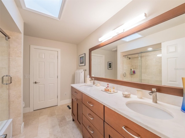 full bathroom featuring a shower stall, a skylight, and a sink