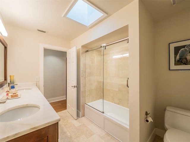 bathroom featuring visible vents, toilet, baseboards, and a sink