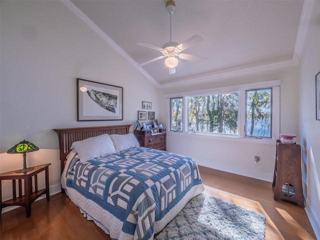 bedroom with baseboards, a ceiling fan, lofted ceiling, and wood finished floors