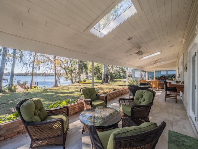 view of patio featuring outdoor lounge area, a water view, and ceiling fan