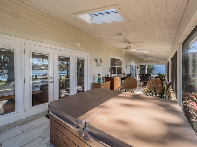 view of patio with a ceiling fan, outdoor dining area, and french doors