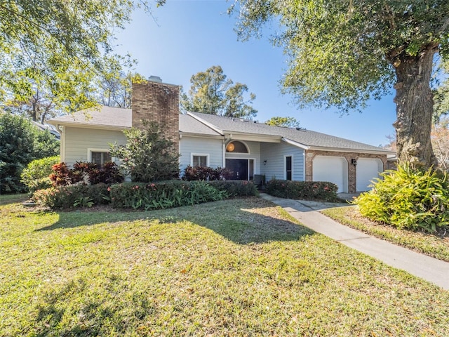 single story home featuring a front lawn, a chimney, and an attached garage