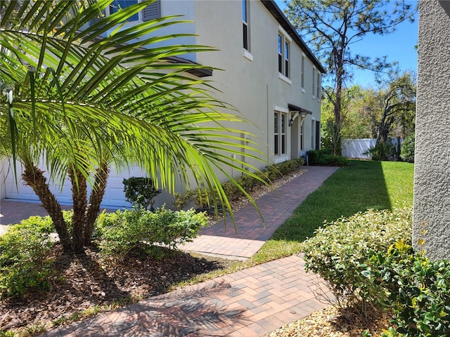 view of yard featuring a garage and fence