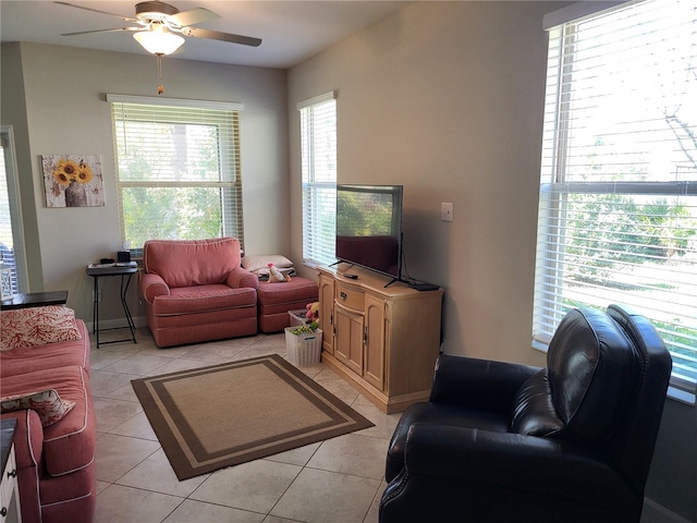 living area featuring light tile patterned floors and a ceiling fan