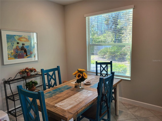 dining area featuring baseboards and light tile patterned flooring