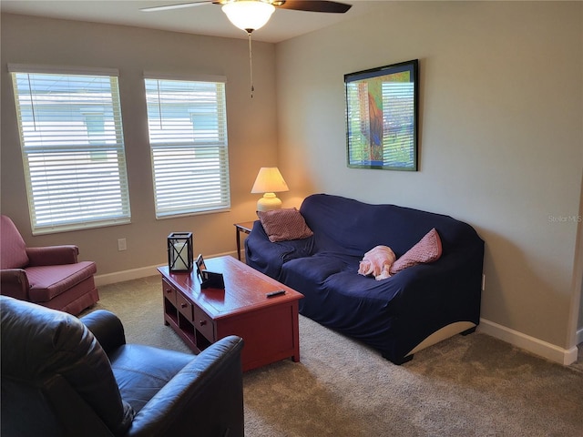 living room with carpet flooring, a ceiling fan, and baseboards