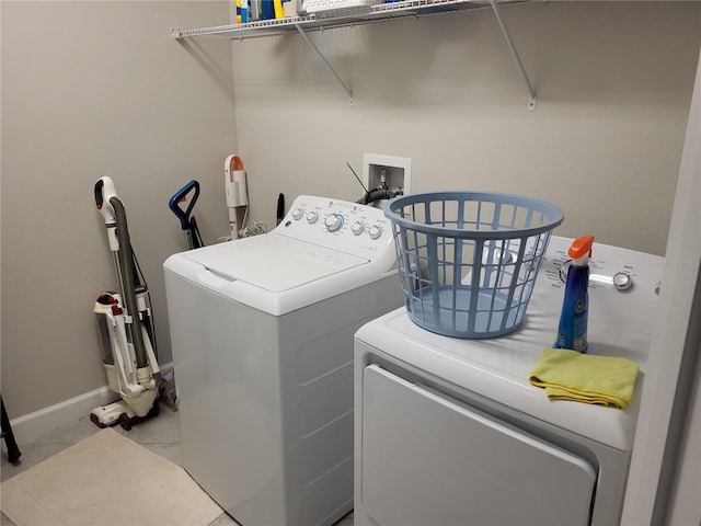 laundry area with laundry area, baseboards, and separate washer and dryer