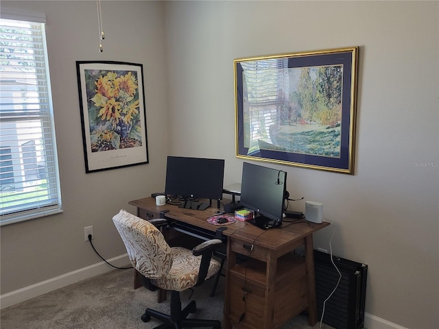 carpeted office featuring baseboards