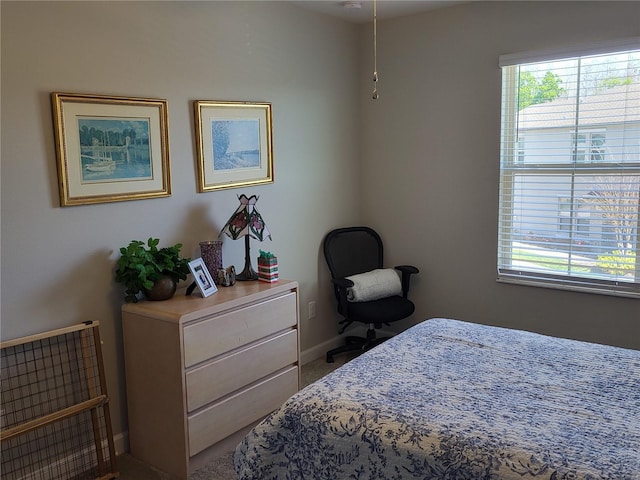 bedroom featuring multiple windows and baseboards