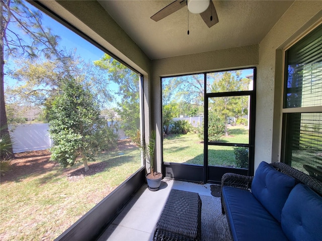 sunroom / solarium featuring a ceiling fan