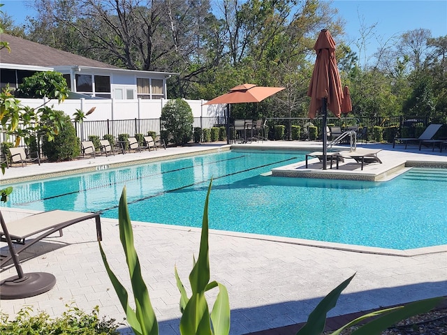 pool featuring a patio and fence