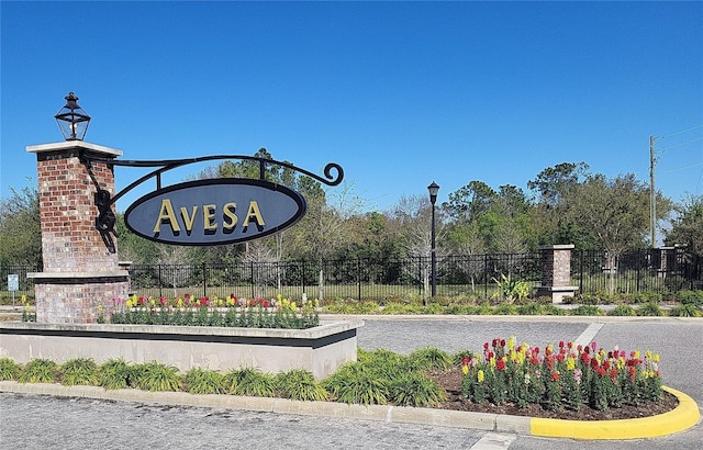 community / neighborhood sign with fence