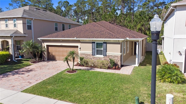 view of front of home with stucco siding, a front lawn, decorative driveway, stone siding, and a garage