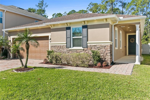 view of front of home featuring stone siding, stucco siding, decorative driveway, and a front yard