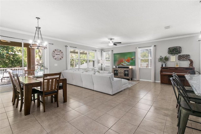 dining area with visible vents, ornamental molding, ceiling fan with notable chandelier, light tile patterned floors, and baseboards