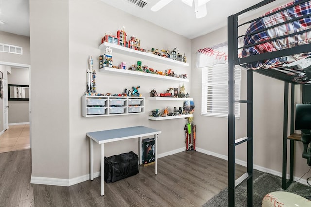 interior space featuring visible vents, baseboards, and wood finished floors