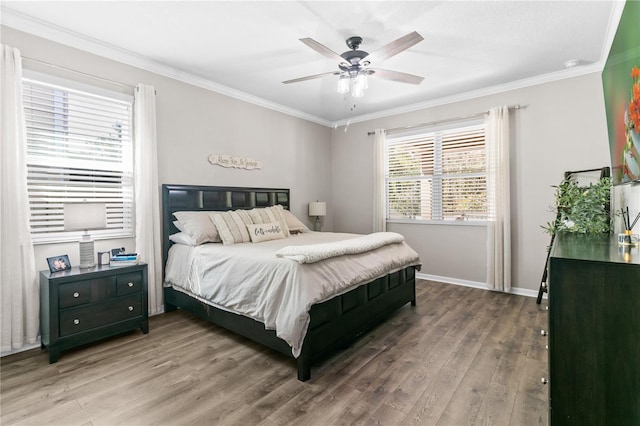 bedroom featuring crown molding, wood finished floors, and baseboards