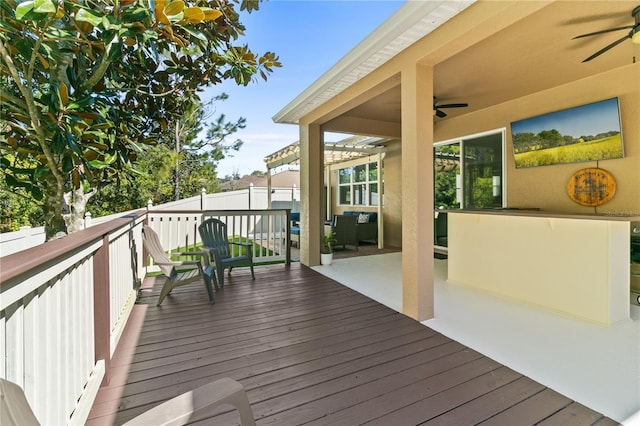 wooden deck featuring ceiling fan, outdoor lounge area, and fence