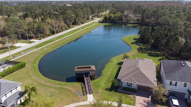 aerial view with a forest view and a water view