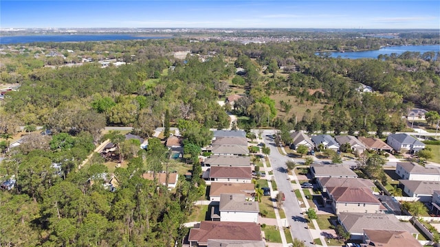 bird's eye view with a forest view, a water view, and a residential view