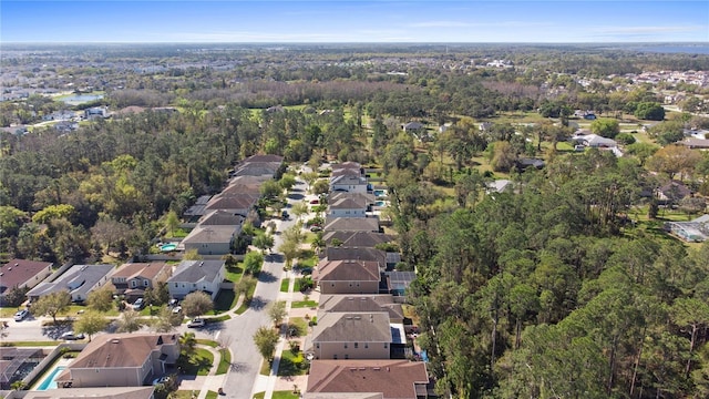 birds eye view of property featuring a residential view and a wooded view