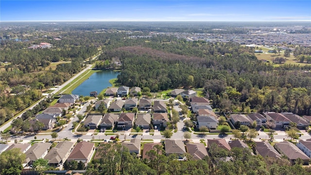 birds eye view of property featuring a view of trees, a water view, and a residential view