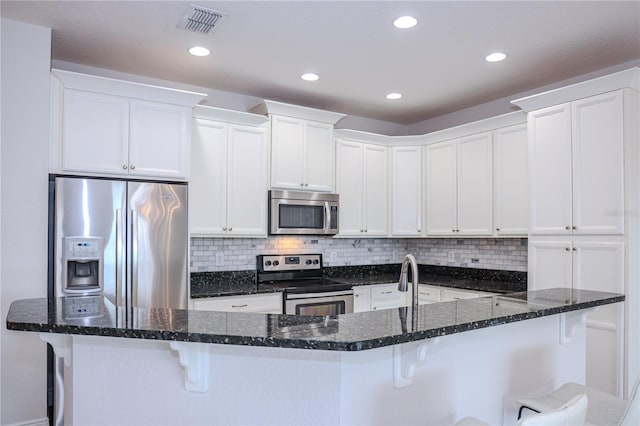 kitchen with stainless steel appliances and white cabinets