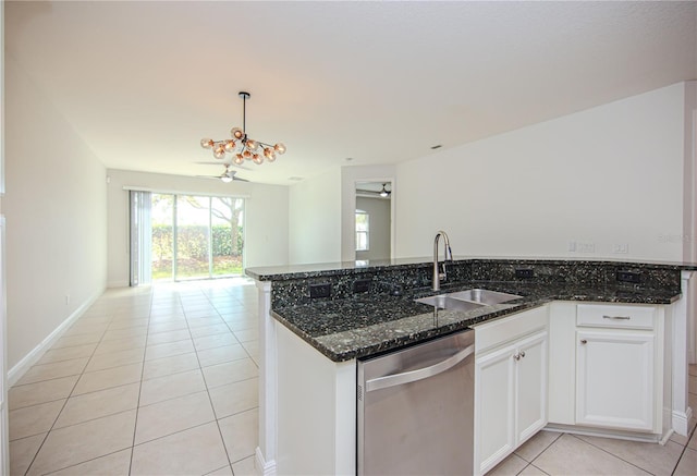 kitchen with light tile patterned floors, dark stone counters, a sink, stainless steel dishwasher, and open floor plan