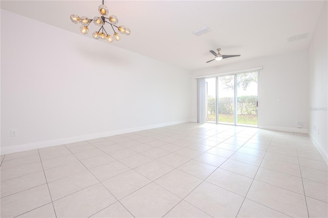 unfurnished room featuring light tile patterned flooring, visible vents, ceiling fan with notable chandelier, and baseboards