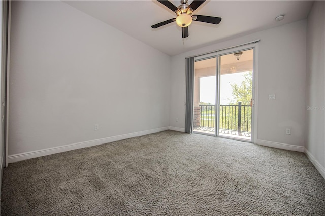 carpeted spare room with lofted ceiling, a ceiling fan, and baseboards