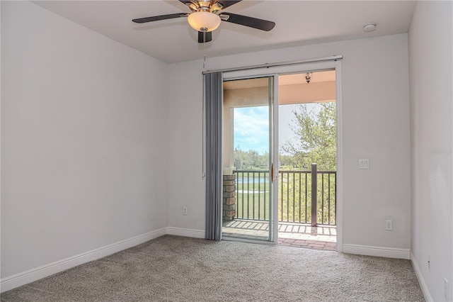 carpeted empty room with baseboards and a ceiling fan