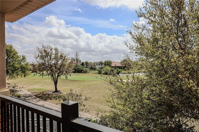 view of yard with a balcony and a water view