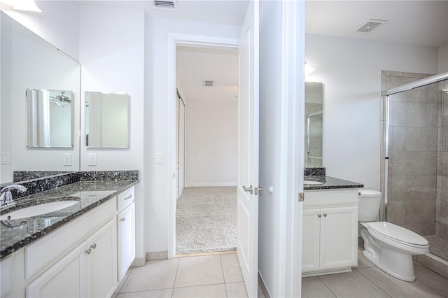 full bath with visible vents, a sink, a shower stall, tile patterned floors, and toilet