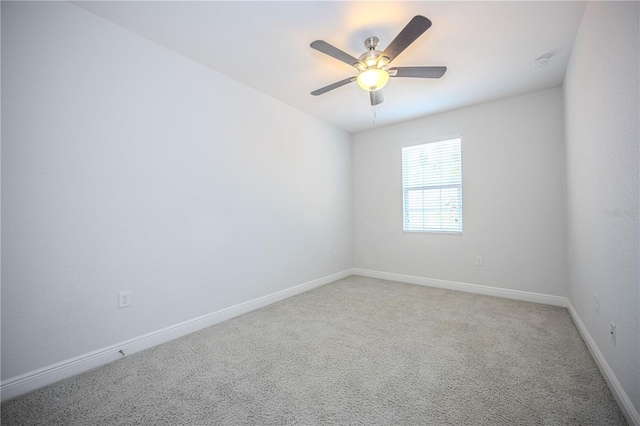 unfurnished room featuring ceiling fan, baseboards, and light carpet