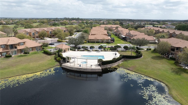 drone / aerial view with a residential view and a water view