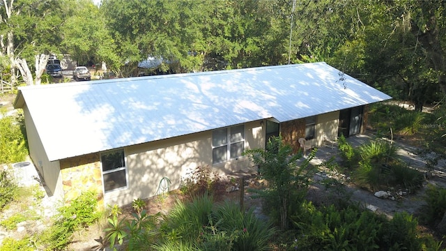 view of side of home with metal roof