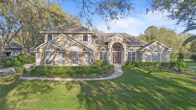 view of front of home featuring stucco siding and a front yard