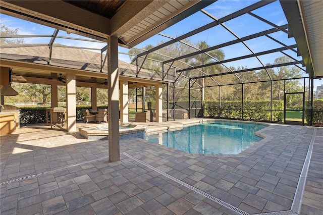 view of pool with a patio, a lanai, a ceiling fan, and a pool with connected hot tub