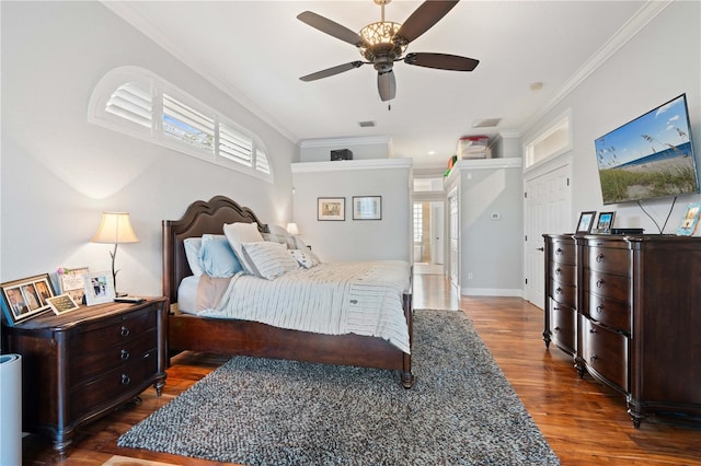 bedroom featuring ceiling fan, crown molding, baseboards, and wood finished floors