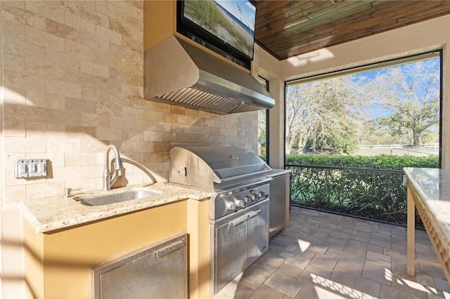 view of patio / terrace with a grill, exterior kitchen, and a sink