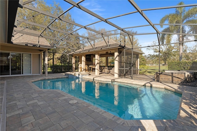 outdoor pool featuring a patio area and glass enclosure