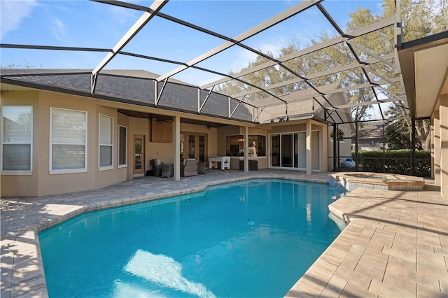 view of pool featuring a lanai, a pool with connected hot tub, a ceiling fan, and a patio