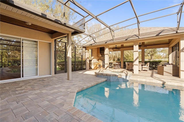 pool with ceiling fan, a lanai, exterior kitchen, a patio area, and an in ground hot tub