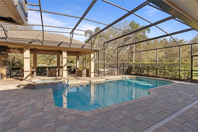 view of pool with area for grilling, a pool with connected hot tub, and a patio area