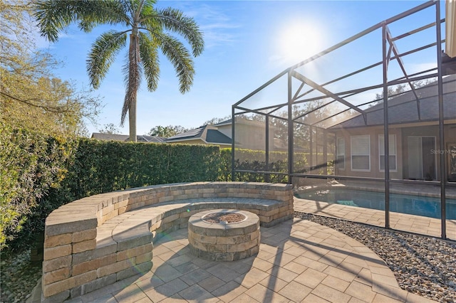 view of patio featuring a lanai, a fenced in pool, and an outdoor fire pit