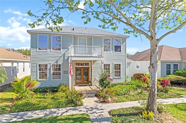 view of front of property featuring a balcony and french doors