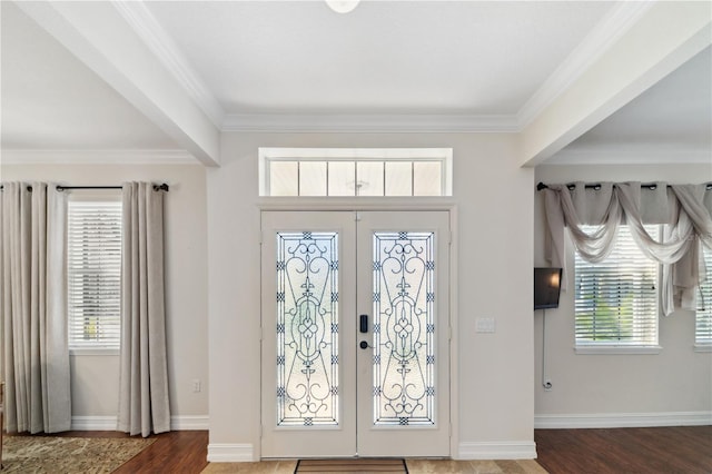 foyer entrance with french doors, wood finished floors, and crown molding