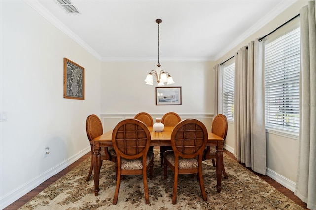 dining room with visible vents, wood finished floors, baseboards, and a chandelier