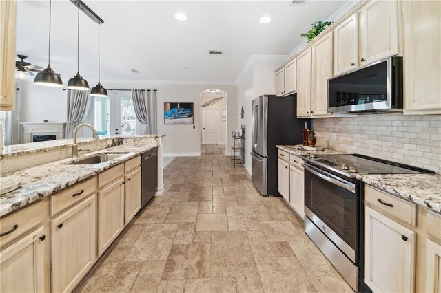 kitchen featuring visible vents, a sink, tasteful backsplash, stone tile flooring, and appliances with stainless steel finishes