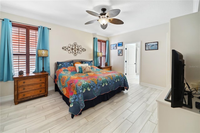 bedroom featuring a ceiling fan, baseboards, and wood tiled floor